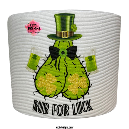 St. Patrick's Day Funny Novelty Toilet Paper Roll Gag Gift | Rub For Luck St. Patrick's Day Funny Toilet Paper Roll by KrcilDesigns.com | Graphic design on a white toilet paper roll, featuring a hairy green ball sack, double fisting shamrock green beers, gold shimmering shamrocks as boobs, shades on, rocking a top hat, and bold black text that reads: "Rub For Luck"
