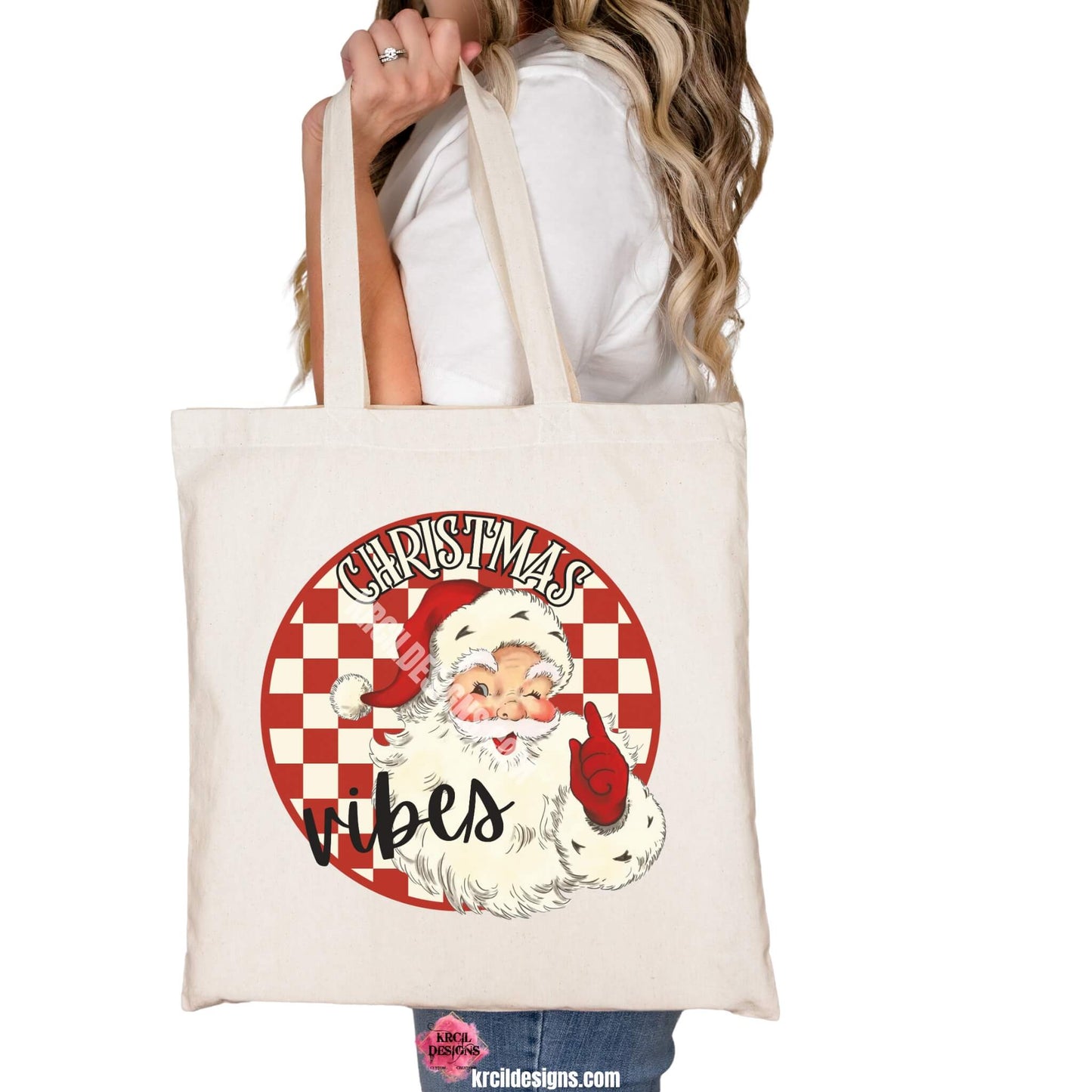 Christmas Tote Bags by KrcilDesigns.com | Graphic design on a canvas tote bag, features a vintage-style Santa Claus with rosy cheeks, winking and pointing, set against a red and white checkered circle background with text that reads: "Christmas Vibes" in bold cream vintage Christmas letters outlined in black.