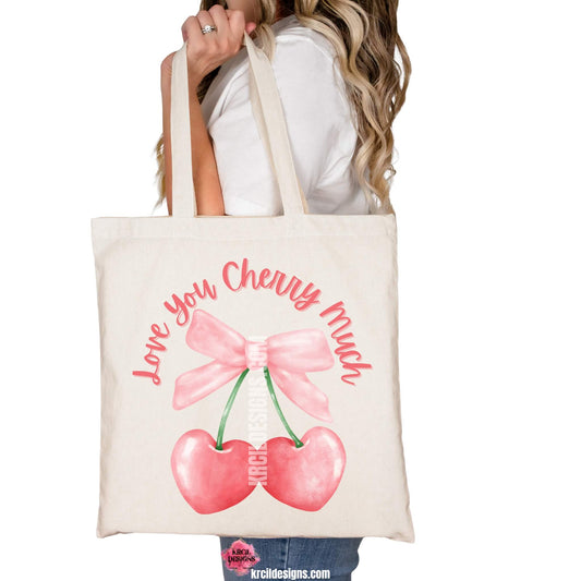 Coquette Bow Tote Bags by KrcilDesigns.com | Graphic design on a canvas tote bag, pink script font text that reads: "Love You Cherry Much" with a watercolor pink coquette bow and two pink cherry hearts dangling from bow.