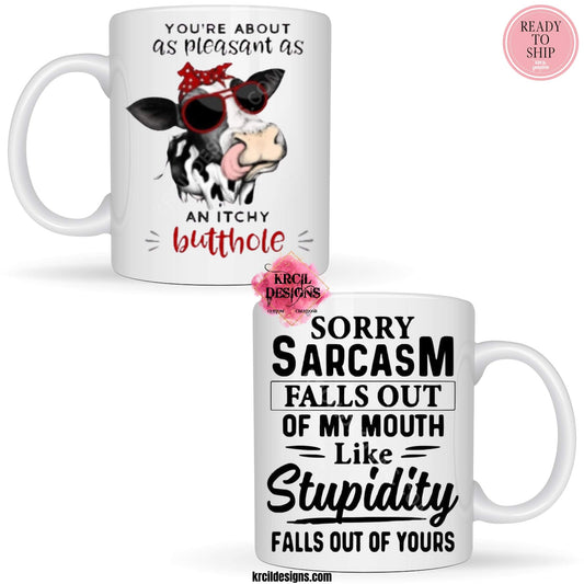 Funny Coffee Mugs by Krcil Designs | A white ceramic mug and sassy quotes on both sides of the mug. Graphic Design: a black and white spotted cow wearing a red and white polka dot bow and sunglasses. Front Side: text that reads: "You're About as Pleasant as an Itchy Butthole" Back Side: text that reads: "Sorry Sarcasm Falls Out Of My Mouth Like Stupidity Falls Out Of Yours" | Shop Coffee Mugs at KrcilDesigns.com