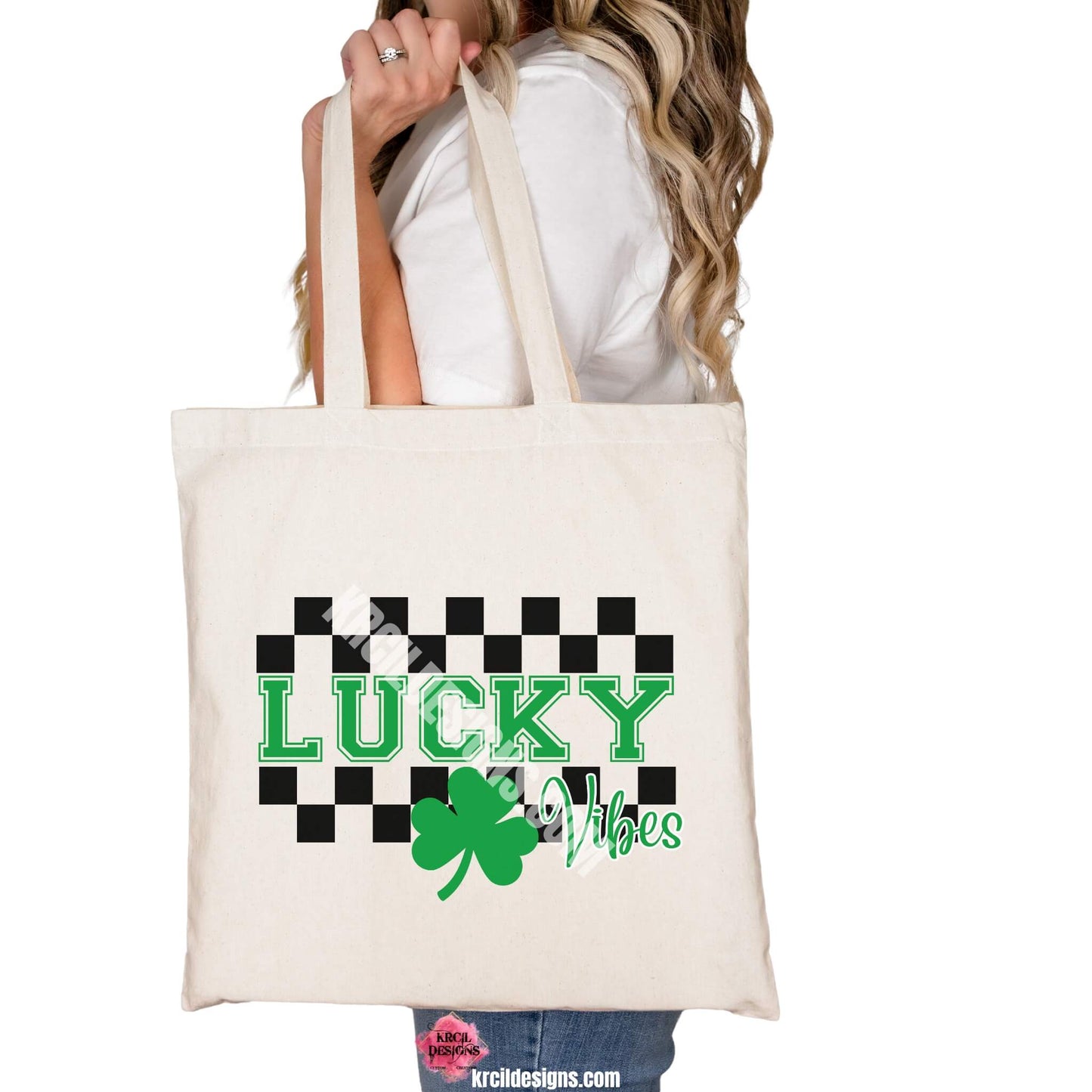 Lucky Vibes Sassy St. Patrick's Day Tote Bag by Krcil Designs | Make a fashion statement with our tote bags! Meet our shopper bags—your new sidekick! You know, the ones that always tag along and never lets you down—it's about to become your favorite fashion accessory! Perfect for grocery shopping or errands. Our graphics showcase a green shamrock the word lucky in green bold letters with a checkered border top and bottom. Shop Tote Bags at KrcilDesigns.com