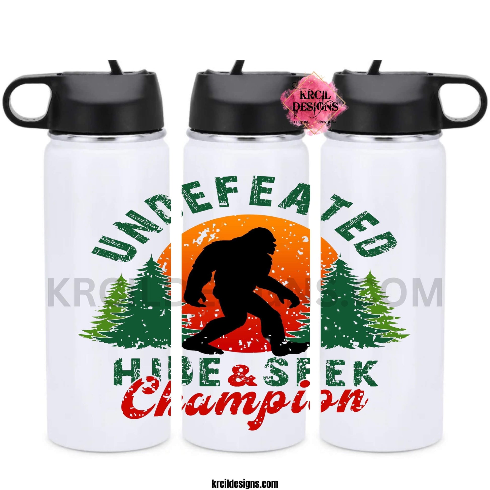 Bigfoot Water Bottles by KrcilDesigns.com | Graphic design on a white water bottle, featuring a graphic of a black silhouette of Bigfoot, walking in front of a red and orange sunset, with green pine trees on both sides, above Bigfoot, text that reads: "UNDEFEATED" in curved distressed bold block capital green letters, below, text that reads: "HIDE & SEEK" in distressed bold block capital green letters, with "Champion" overlay in bold red handwriting script.