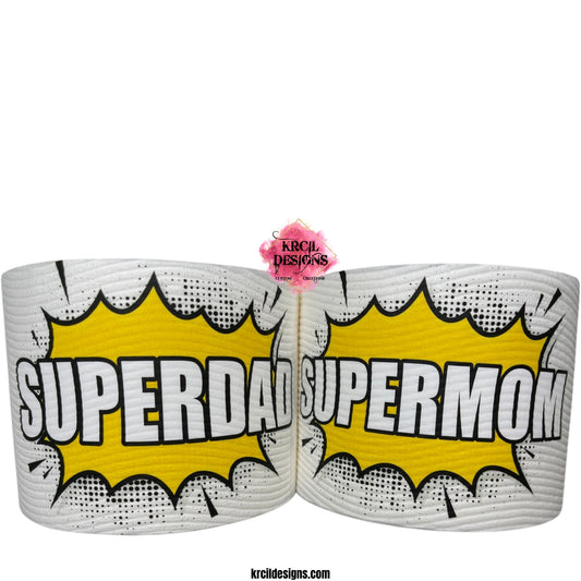 Superhero Toilet Paper by KrcilDesigns.com | Graphic design on white toilet paper roll, featuring a bold comic book-style graphic in center, showcases a bright yellow explosion shape with sharp black jagged edges and a dotted halftone pattern around the perimeter, in the middle of the explosion, in all caps text that reads: "SUPERDAD" or "SUPERMOM" with thick, bold white letters outlined in black. The design captures an energetic, superhero vibe, celebrating dads and moms as powerful and unstoppable.