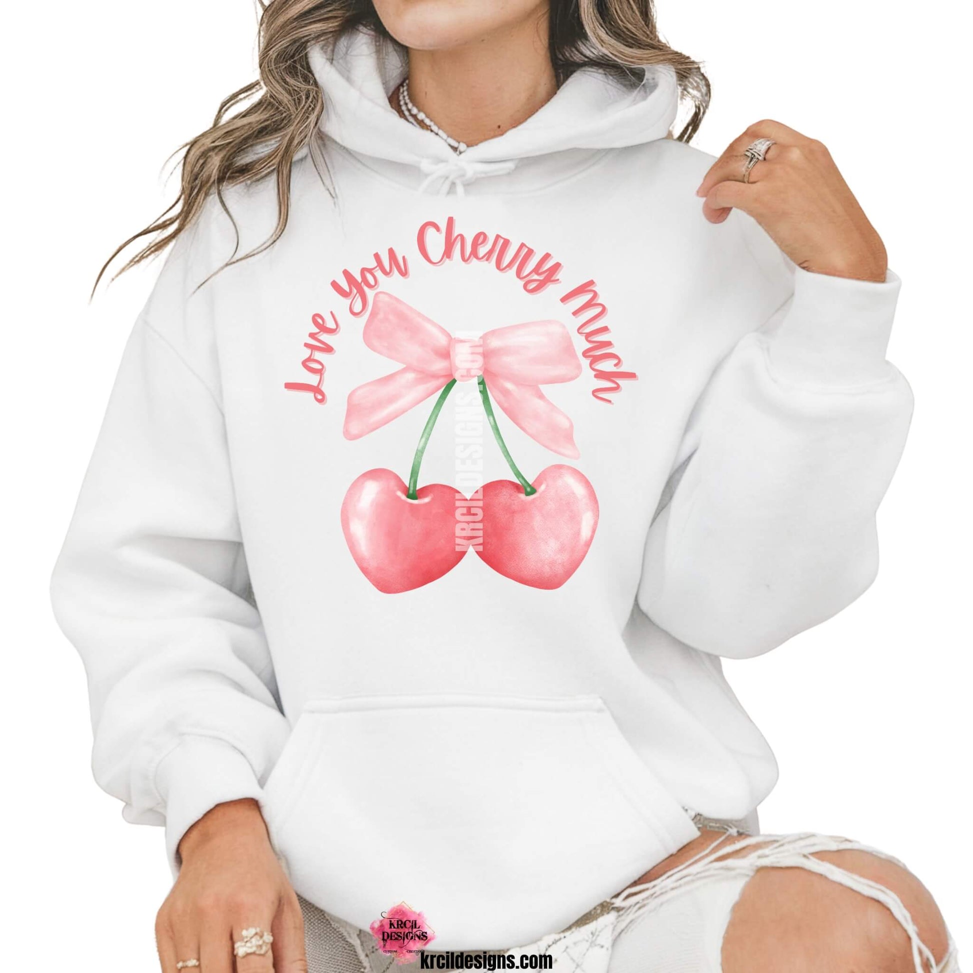 Coquette Bow Shirts by KrcilDesigns.com | Graphic design on a white hoodie, pink script font text that reads: "Love You Cherry Much" with a watercolor pink coquette bow and two pink cherry hearts dangling from bow.
