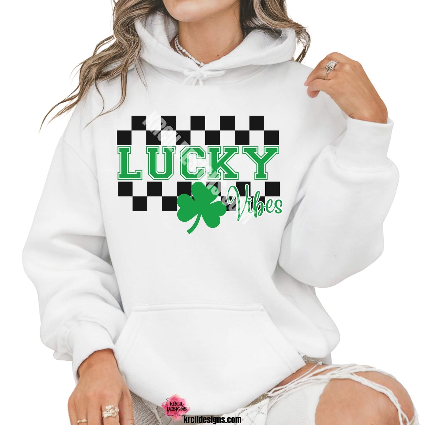 Lucky Vibes St. Patrick's Day Sweatshirt by Krcil Designs | Make a fashion statement with our crewneck sweatshirts and pull over hoodies! Our buttery soft cozy shirts will become your new weekend bestie! Get your green on this St. Patty's Day! Run your errands in style with our St. Patty's Day tote bag! Our graphics showcase a green shamrock the word lucky in green bold letters with a checkered border top and bottom. Shop Sweatshirts and Hoodies at KrcilDesigns.com