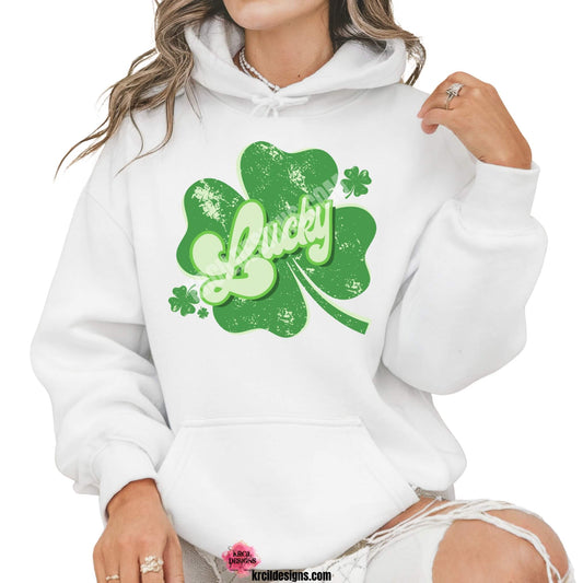 Distressed Retro Lucky Shamrock St. Patrick's Day Sweatshirt by Krcil Designs | Make a fashion statement with our sweatshirts and hoodies! Our buttery soft cozy shirts will become your new weekend bestie! Get your green on this St. Patty's Day! Run your errands in style with our St. Patty's Day tote bag! Our graphics showcases the word Lucky in retro style green letters, outlined in two shades of green, layered on a shamrock, with floating shamrocks on sides. Shop Sweatshirts and Hoodies at KrcilDesigns.com