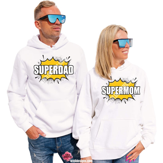 Superhero Sweatshirts by KrcilDesigns.com | Graphic design on white hoodies, featuring a bold comic book-style graphic in center, showcases a bright yellow explosion shape with sharp black jagged edges and a dotted halftone pattern around the perimeter, in the middle of the explosion, in all caps text that reads: "SUPERDAD" or "SUPERMOM" with thick, bold white letters outlined in black. The design captures an energetic, superhero vibe, celebrating dads and moms as powerful and unstoppable.