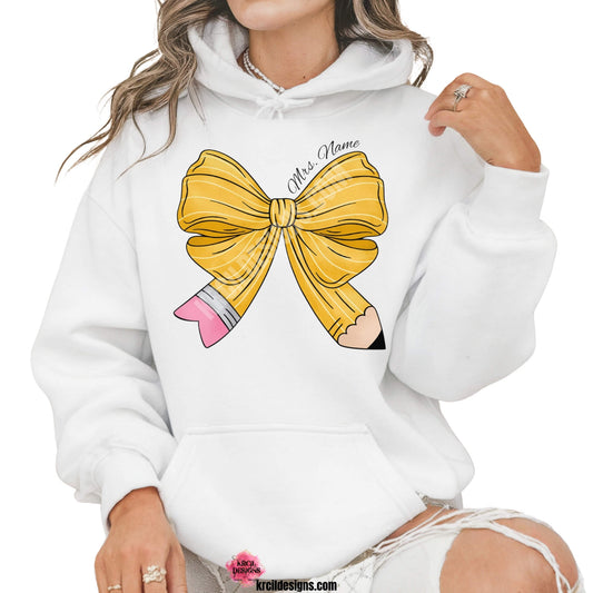 Coquette Bow Shirts by KrcilDesigns.com | Graphic design on a white hoodie, a coquette bow in a pencil pattern design, features your name, curved around top of bow in a black script font that reads: "Mrs. Name" for a teacher shirt.
