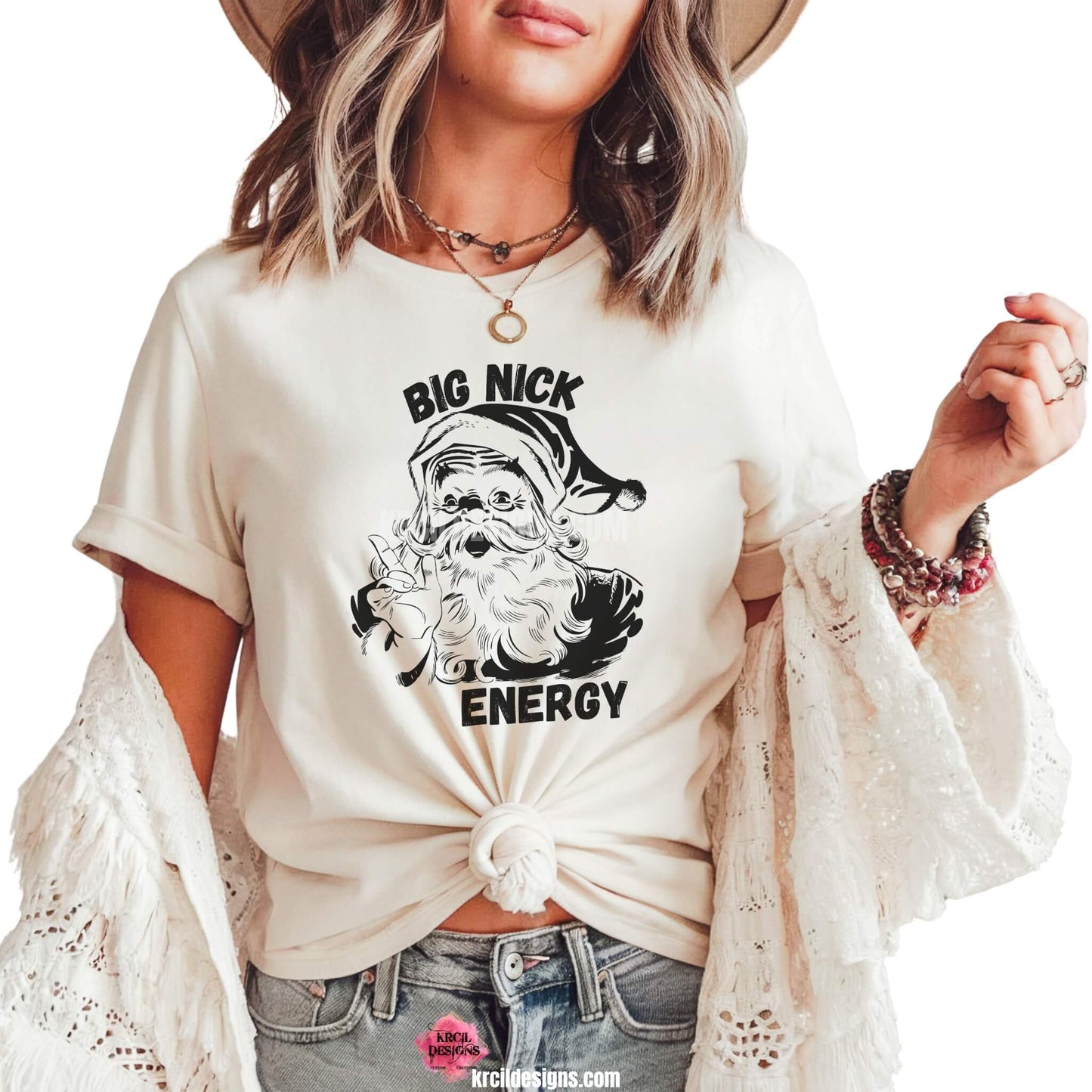 Christmas Tees by KrcilDesigns.com | Graphic design on a white t-shirt, features an all black silhouette design, a vintage-style Santa Claus, waving and pointing his index finger, with text that reads: "Big Nick Energy" in bold capital black block letters.