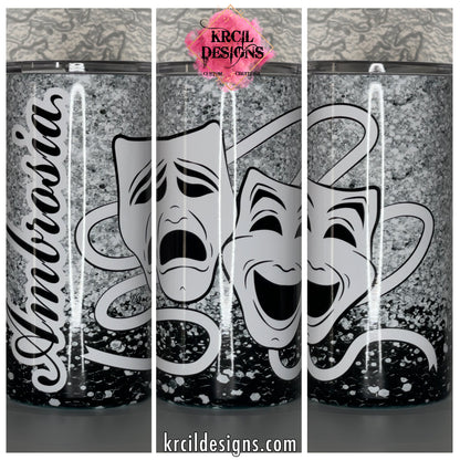 Comedy and Tragedy Mask Tumbler by Krcil Designs | This coffee tumbler features a glitzy and glam design and is the perfect accessory for anyone in performing arts, whether you're a performer, actor, director. This custom tumbler features the iconic comedy and tragedy mask, on a backdrop of silver and black faux glitter. Give it a personal touch, add name or one of your favorite theatre arts quotes, for a one-of-a-kind personalized tumbler. Shop Gifts for Theatre Actors at KrcilDesigns.com