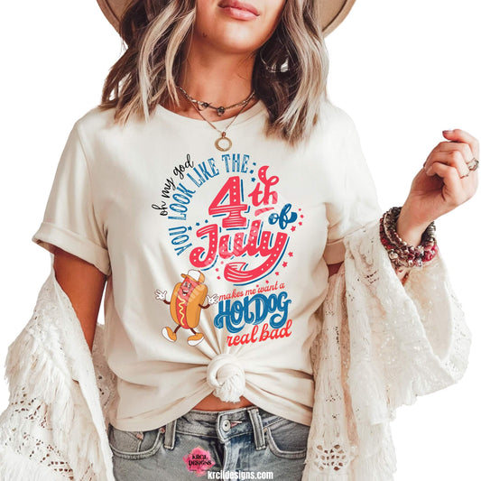 4th of July Funny Shirts by KrcilDesigns.com | Graphic design on a white t-shirt, featuring a dancing smiling cartoon hot dog wearing sneakers, a baseball cap, and hands are waving. Colorful text in red, white, and blue colors, in a variety of fonts, text that reads: "Oh My God You Look Like The 4th of July Makes Me Want A Hot Dog Real Bad" Fun, festive, and perfect for Independence Day celebrations!