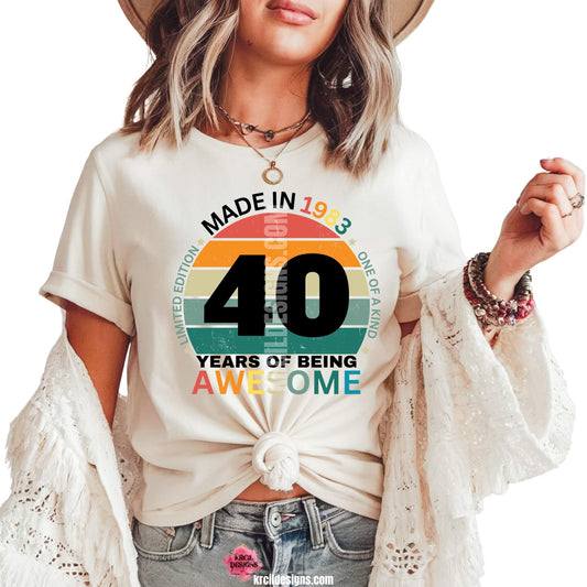 Birthday Shirts by KrcilDesigns.com | Retro-style graphic design on a white t-shirt featuring the text "Made in [YEAR]" above a vintage sunset circle with horizontal stripes in orange, yellow, green, and teal. Bold black numbers "[AGE]" are centered in the design, with additional text below reading "Years of Being Awesome" Surrounding the circle are phrases like "Limited Edition" and "One of a Kind" The design has a nostalgic 80s vibe perfect for birthday celebrations.