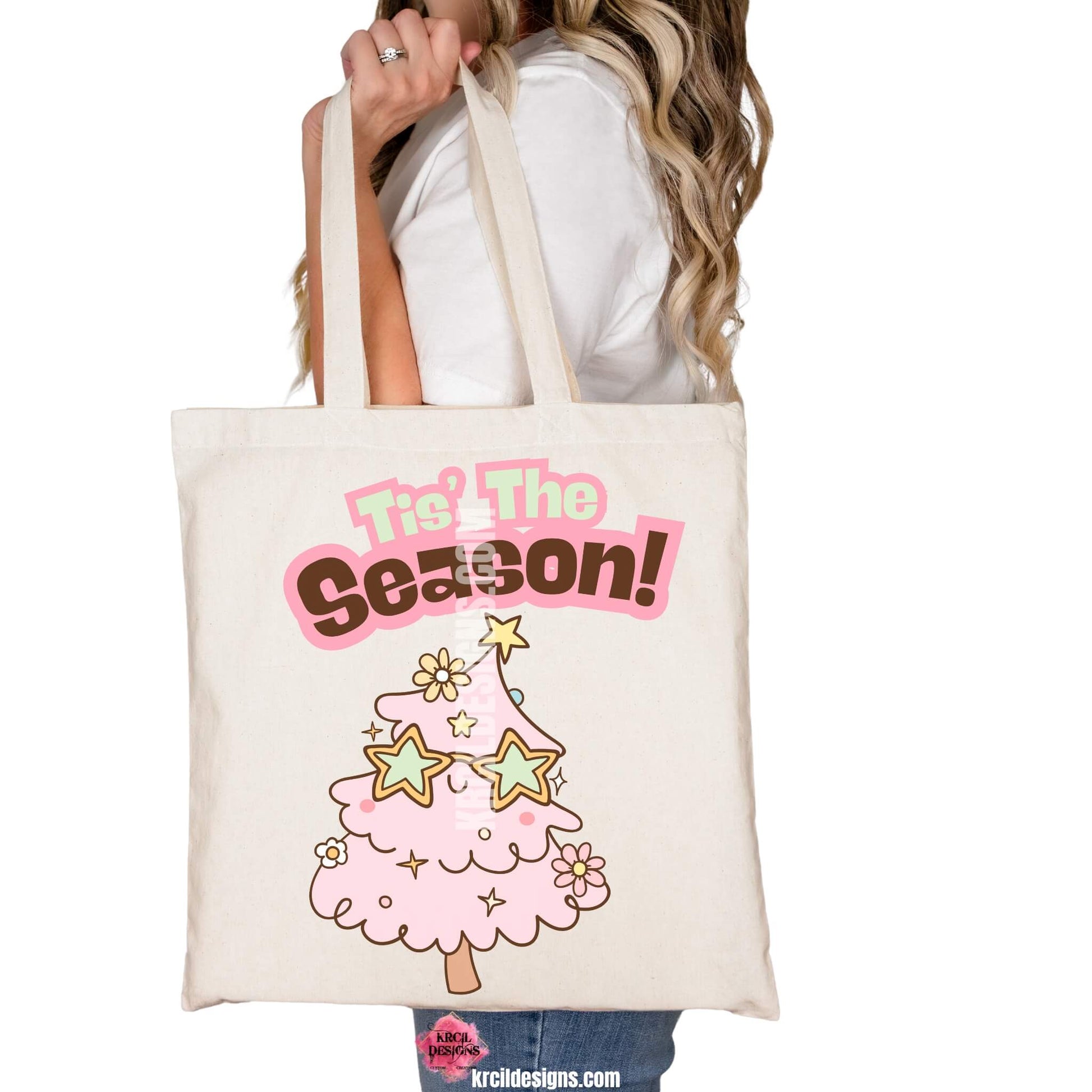 Christmas Tote Bags by KrcilDesigns.com | Graphic design on a canvas tote bag, features a cute pink Christmas tree wearing star-shaped sunglasses, decorated with pastel stars and pastel daisy flowers, with text that reads: "Tis' The Season!" in bold retro-style pink, green, and brown lettering curved above the tree.