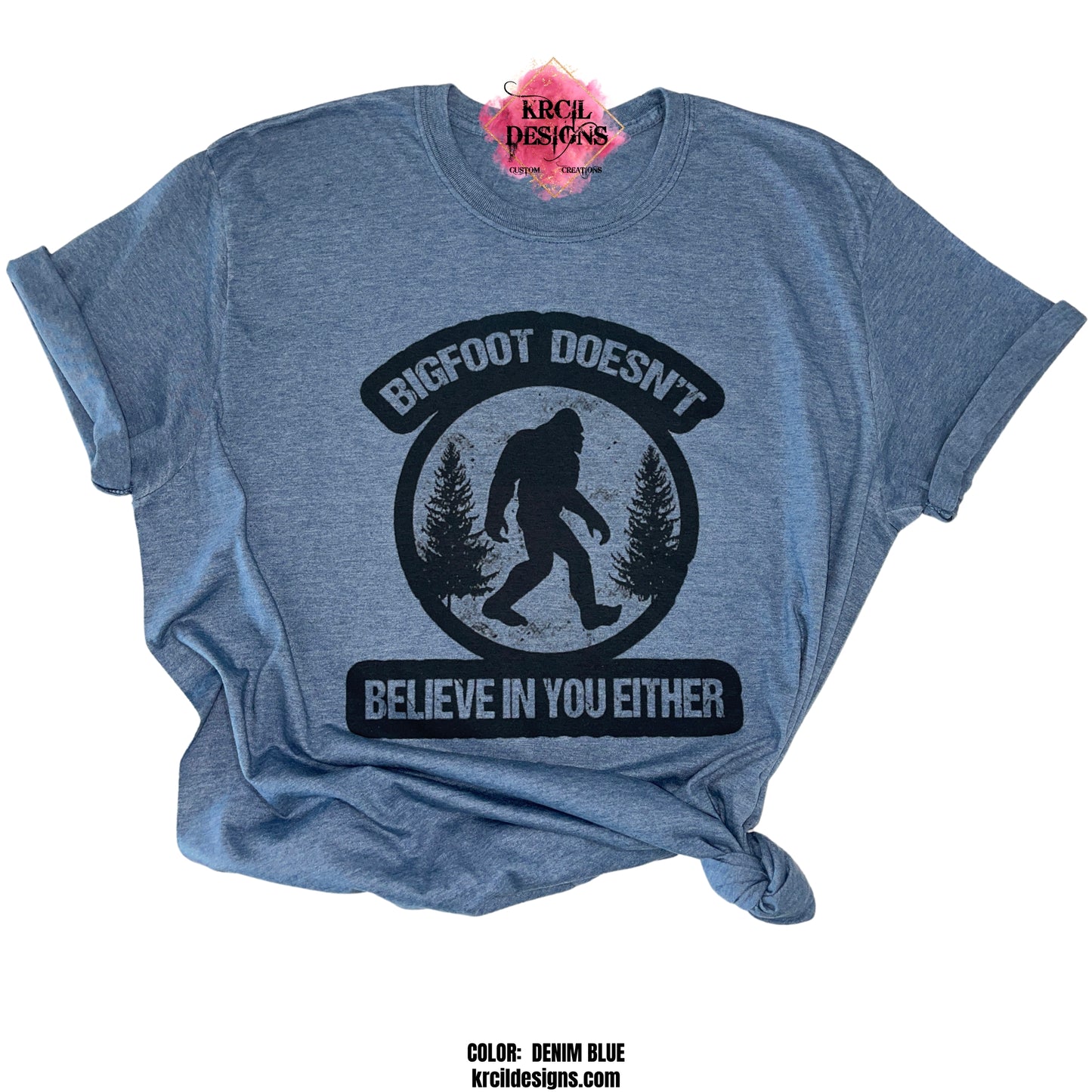 DENIM BLUE | Show off your sense of humor with our Sasquatch T-Shirt "Bigfoot Doesn't Believe In You Either" Bigfoot T-Shirt by Krcil Designs! Featuring Bigfoot! The Bigfoot Tee that's a conversation starter at the Bigfoot Festival or on Bigfoot Day. Don't miss the fun — grab your Sasquatch Tee before it disappears into the woods! Give the gifts for Bigfoot lovers that make them roar with laughter! Keep the Bigfoot Legend Alive! Sasquatch: The Legend of Bigfoot! Shop Bigfoot Gifts at KrcilDesigns.com