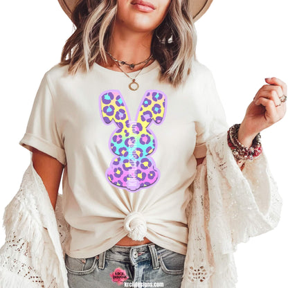 Pastel Cheetah Print Easter Bunny T-Shirt by Krcil Designs | Make a fashion statement with our graphic tees t-shirts! Our buttery soft cozy tees will become your new weekend bestie! Get ready to hop into fun with our fun Easter shirt! Our graphic design, showcases a pastel cheetah print bunny and vibrant splashes of Easter colors. This Easter, celebrate in style with matching family shirts—perfect for family photos! Shop Easter Shirts at KrcilDesigns.com