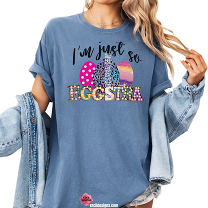 I'm just so EGGSTRA Easter T-Shirt by Krcil Designs | Make a fashion statement with our graphic tees t-shirts! Our buttery soft cozy tees will become your new weekend bestie! Get ready to hop into fun and show off your vibrant personality with our "I'm just so EGGSTRA" Easter shirt! Our graphic design, showcasing vibrant, bright, colorful Easter eggs and a fun, playful message. This Easter, celebrate in style with matching family shirts—perfect for family photos! Shop Easter Shirts at KrcilDesigns.com