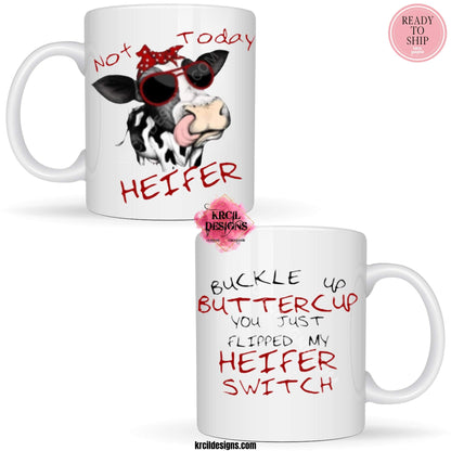 Funny Coffee Mugs by Krcil Designs | A white ceramic mug and sassy quotes on both sides of the mug. Graphic Design: a black and white spotted cow wearing a red and white polka dot bow and sunglasses. Front Side: text that reads: "Not Today Heifer" Back Side: text that reads: "Buckle Up Buttercup You Just Flipped My Heifer Switch" | Shop Coffee Mugs at KrcilDesigns.com