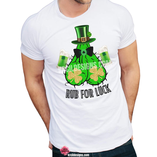 Rub For Luck St. Patrick's Day Funny Shirts by KrcilDesigns.com | Graphic design on a white t-shirt, featuring a hairy green ball sack, double fisting shamrock green beers, gold shimmering shamrocks as boobs, shades on, rocking a top hat, and bold black text that reads: "Rub For Luck"