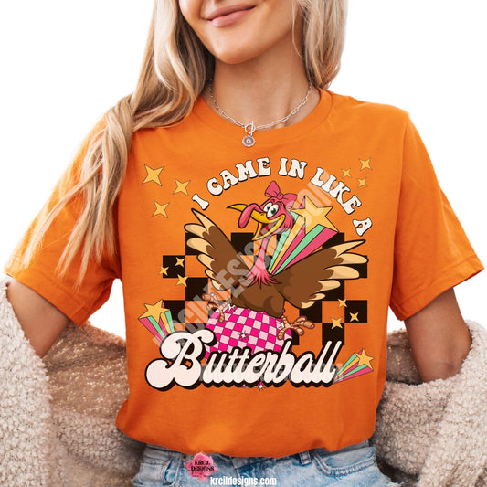 Funny Thanksgiving Shirts by KrcilDesigns.com | Graphic design on a orange t-shirt, featuring a fun Thanksgiving-themed design of a cartoon turkey swinging in on a disco ball in light pink and dark pink pattern, wearing a pink bow, surrounded by yellow stars, colorful retro stripes, and a black checkered background. Bold text above that reads: "I Came In Like A" with "Butterball" in large retro font below.