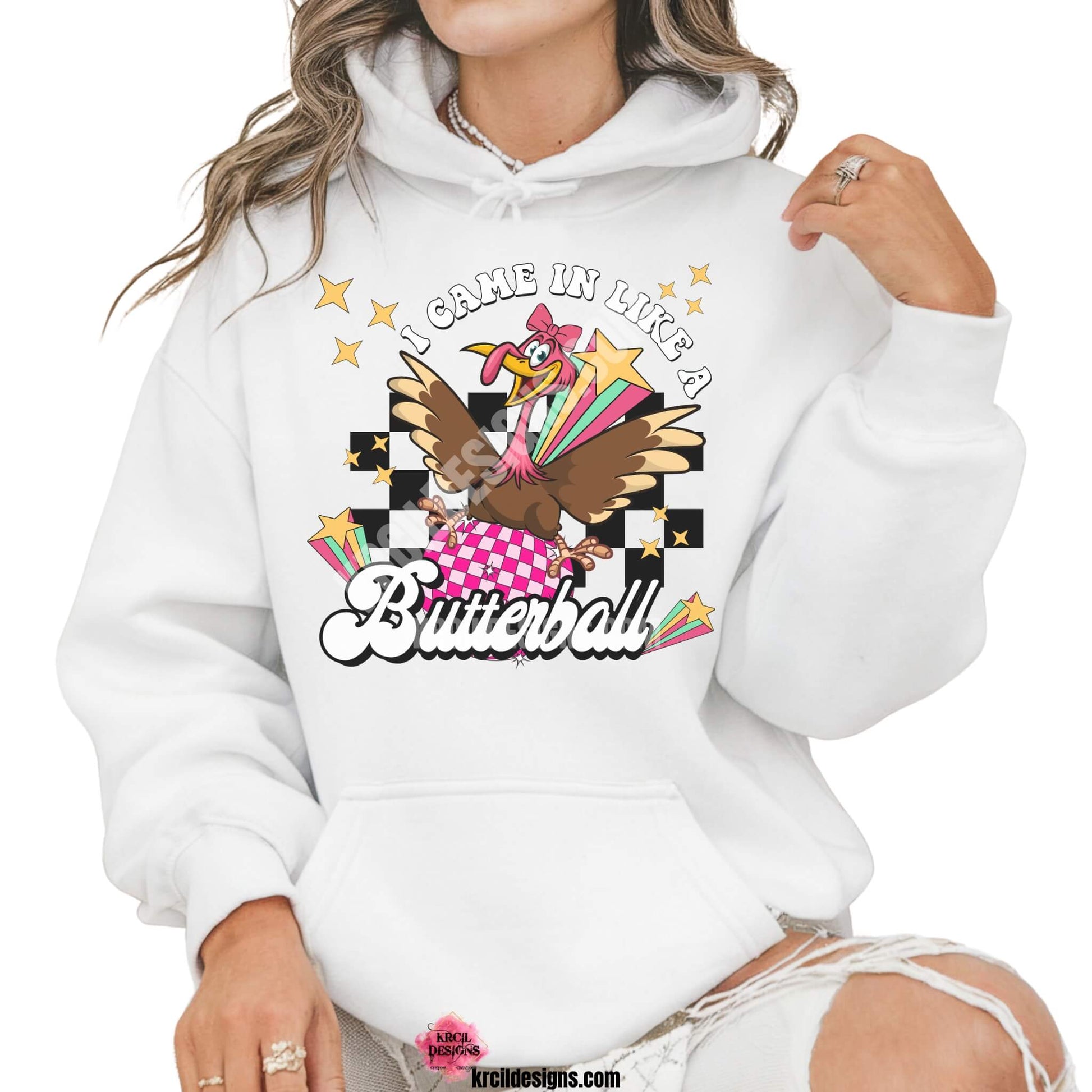 Funny Thanksgiving Shirts by KrcilDesigns.com | Graphic design on a white hoodie, featuring a fun Thanksgiving-themed design of a cartoon turkey swinging in on a disco ball in light pink and dark pink pattern, wearing a pink bow, surrounded by yellow stars, colorful retro stripes, and a black checkered background. Bold text above that reads: "I Came In Like A" with "Butterball" in large retro font below.