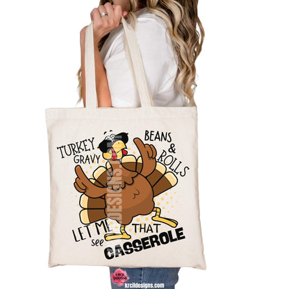 Thanksgiving Funny Tote Bags by KrcilDesigns.com | Graphic design on a canvas tote bag, featuring a cartoon turkey wearing sunglasses, the turkey is brown with a red wattle, yellow beak and feet, with yellow dots as a background. The words are scattered around the turkey in bold black text that reads: "Turkey Gravy Beans & Rolls LET ME SEE THAT CASSEROLE"