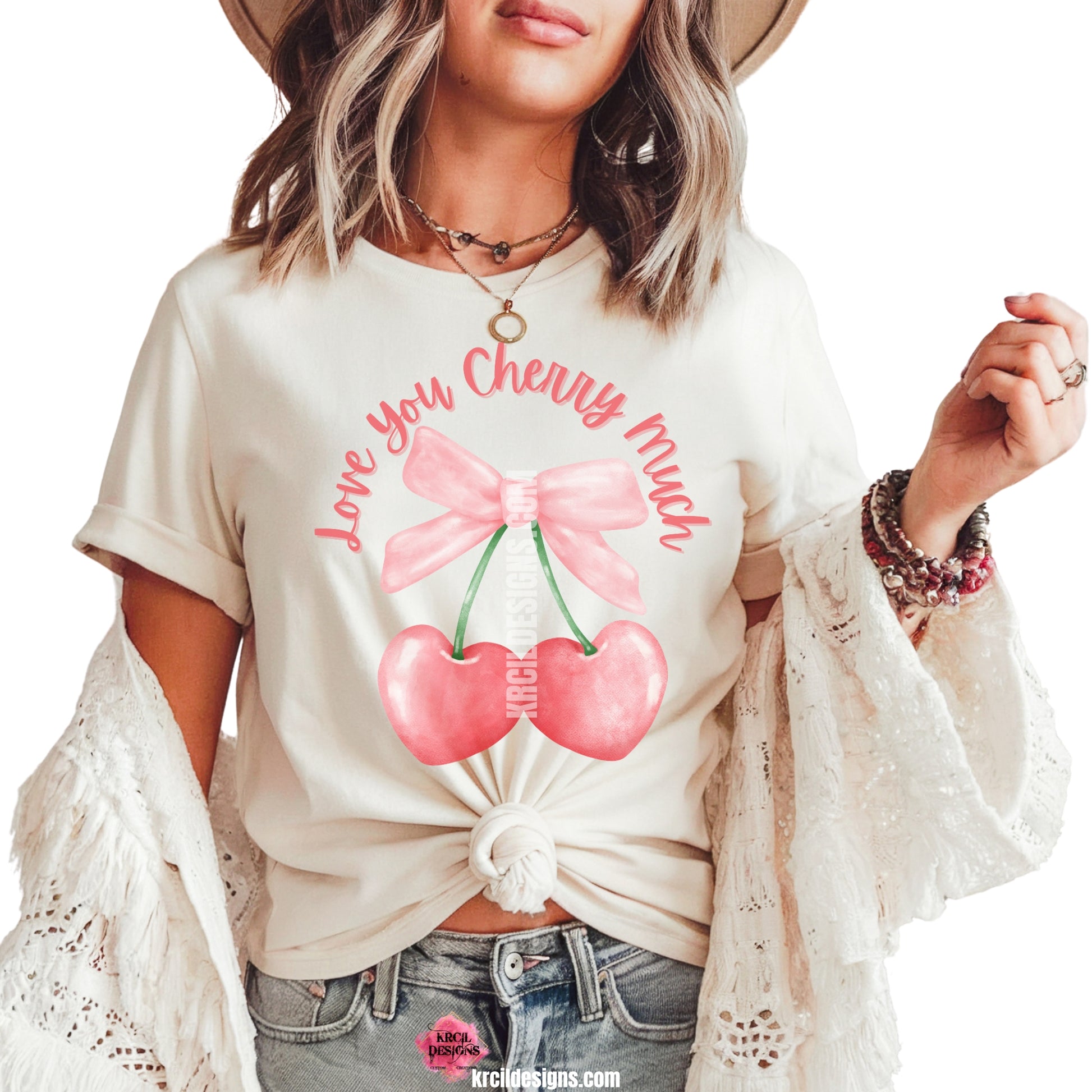 Love You Cherry Much Coquette Bow Cherries T-Shirt by Krcil Designs | Make a fashion statement with our graphic tees t-shirts! Our buttery soft cozy tees will become your new weekend bestie! Our tee shirt graphics showcases a soft pink coquette bow with dangling heart shaped cherries and "Love You Cherry Much" wraps around the top of bow. Shop Graphic Tees T-Shirts at KrcilDesigns.com