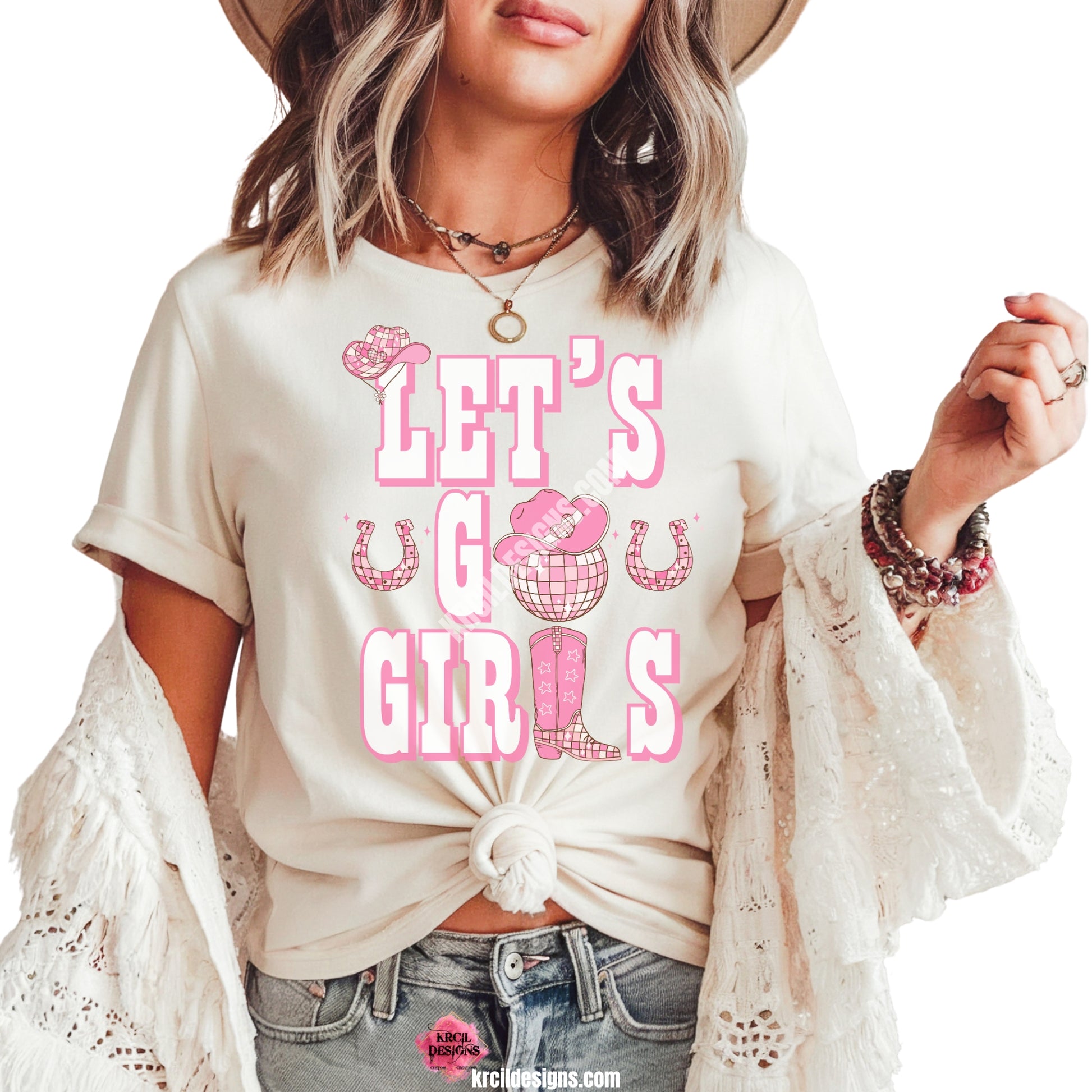 Let's Go Girls Country Graphic Tee T-Shirt by Krcil Designs | Make a fashion statement with our graphic tees t-shirts! Our buttery soft cozy tees will become your new weekend bestie! Introducing our super cute t-shirt made just for girls! Featuring the iconic quote: "LET'S GO GIRLS" in bold white letters outlined in soft pink with a matching cowboy boot, cowboy hat, horseshoes, and a disco ball. Shop Graphic Tees T-Shirts at KrcilDesigns.com