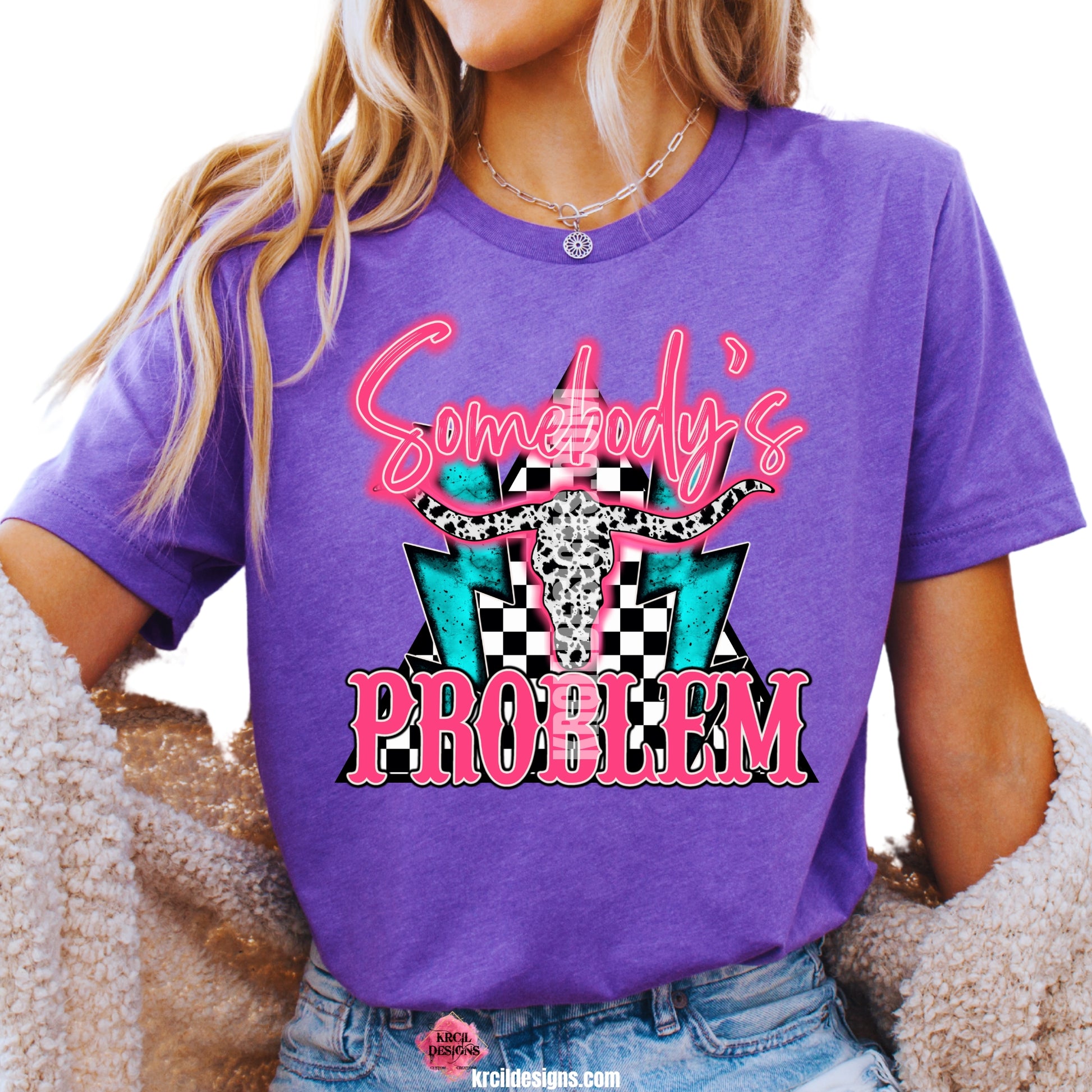 Sassy Graphic Tees T-Shirts by KrcilDesigns.com | Graphic design on a purple t-shirt, featuring hot pink text that reads: "Somebody's PROBLEM" with "Somebody's" as a handwritten font at top and "PROBLEM" in all caps block-letter font at bottom, with cowhide bullhorns at its center, black and white checkered triangle background, and turquoise lighting bolts.