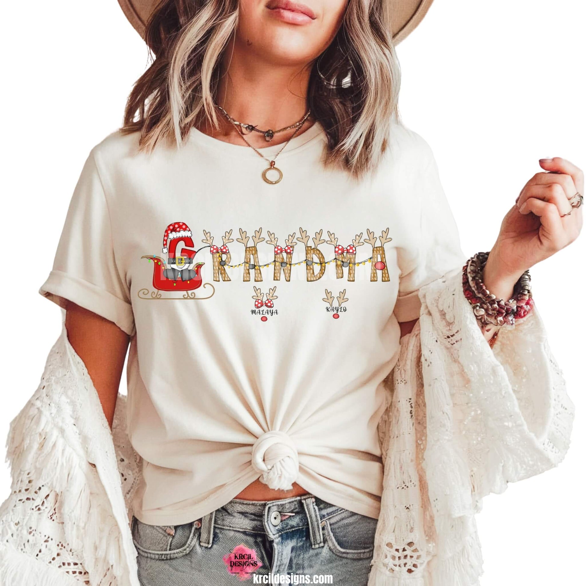 Christmas Personalized Name Shirts by KrcilDesigns.com | Graphic Design on a white t-shirt, reads: "GRANDMA" stars a "G" that's gone full Santa mode, dressed up in Santa's Suit and Santa's Hat, riding in Santa's sleigh with twinkling Christmas lights, while the rest of the "Grandma" letters are transformed into Santa's Reindeer. Featuring reindeer antlers, bows, and Rudolph's Red Nose. Add grandkids names as little reindeer! Not just for Grandma, we have them for everyone!