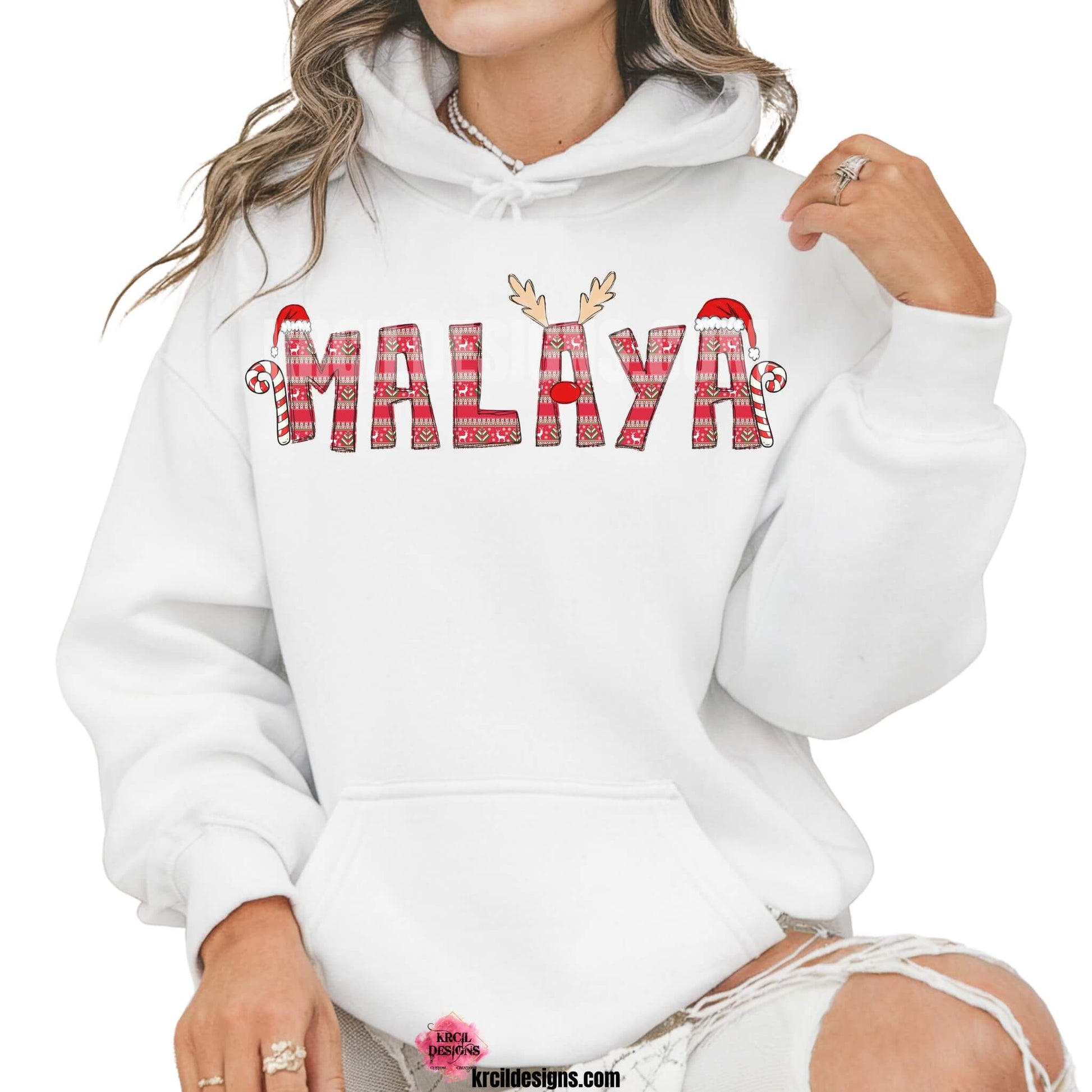 Christmas Personalized Name Shirts, Sweatshirts, Hoodies, by KrcilDesigns.com | Graphic Design on a white hoodie, features your name, in name style option: "Ugly Sweater" where all letters are the same festive design in an ugly sweater pattern. The letters, one adorned with Rudolph's Red Nose, Reindeer Antlers, plus, Santa Hats and Candy Canes on each side of your name.