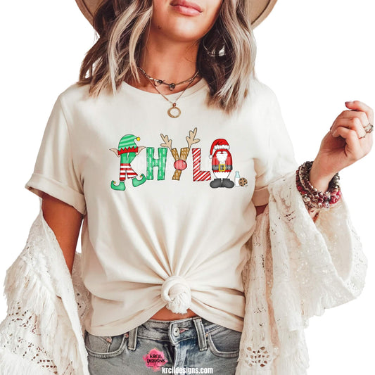 Christmas Personalized Name Shirts by KrcilDesigns.com | Graphic Design on a white t-shirt, features your name, in name style option: "Santa & Elf" where the designs of the letters are different festive Christmas patterns. The playful letters adorned with Santa, His Elf, Rudolph's Red Nose, Reindeer Antlers, and even Santa's Milk and Cookies.