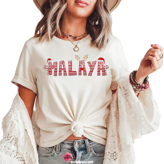 Christmas Personalized Name Shirts by KrcilDesigns.com | Graphic Design on a white t-shirt, features your name, in name style option: "Ugly Sweater" where all letters are the same festive design in an ugly sweater pattern. The letters, one adorned with Rudolph's Red Nose, Reindeer Antlers, plus, Santa Hats and Candy Canes on each side of your name.