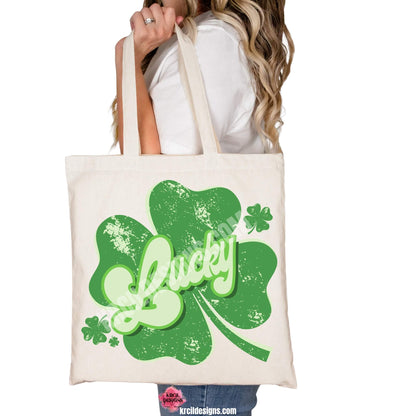 Lucky Shamrock St. Patrick's Day Retro Tote Bags by Krcil Designs | Make a fashion statement with our tote bags! Meet our shopper bags—your new sidekick! You know, the ones that always tag along and never lets you down—it's about to become your favorite fashion accessory! Perfect for grocery shopping or errands. Our graphics showcases the word Lucky in retro style green letters, outlined in two shades of green, placed on top of a shamrock, floating shamrocks on the sides. Shop Tote Bags at KrcilDesigns.com
