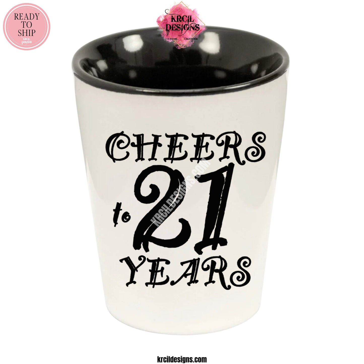 "Cheers to 21 Years" Shot Glass by Krcil Designs | Get ready to toast to the good times with our custom personalized shot glasses, perfect for the man cave. Pair them with your favorite bottle of liquor and put them in a basket for the ultimate gift. Don't forget to add the matching dish cloth tea towel set! Explore our sets and bundles options for gift ideas. Perfect for birthdays and holidays. Two toned, black interior, white exterior, ceramic shot glass. KrcilDesigns.com