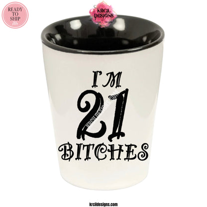 "I'm 21 Bitches" Shot Glass by Krcil Designs | Get ready to toast to the good times with our custom personalized shot glasses, perfect for the man cave. Pair them with your favorite bottle of liquor and put them in a basket for the ultimate gift. Don't forget to add the matching dish cloth tea towel set! Explore our sets and bundles options for gift ideas. Perfect for birthdays and holidays. Two toned, black interior, white exterior, ceramic shot glass. KrcilDesigns.com