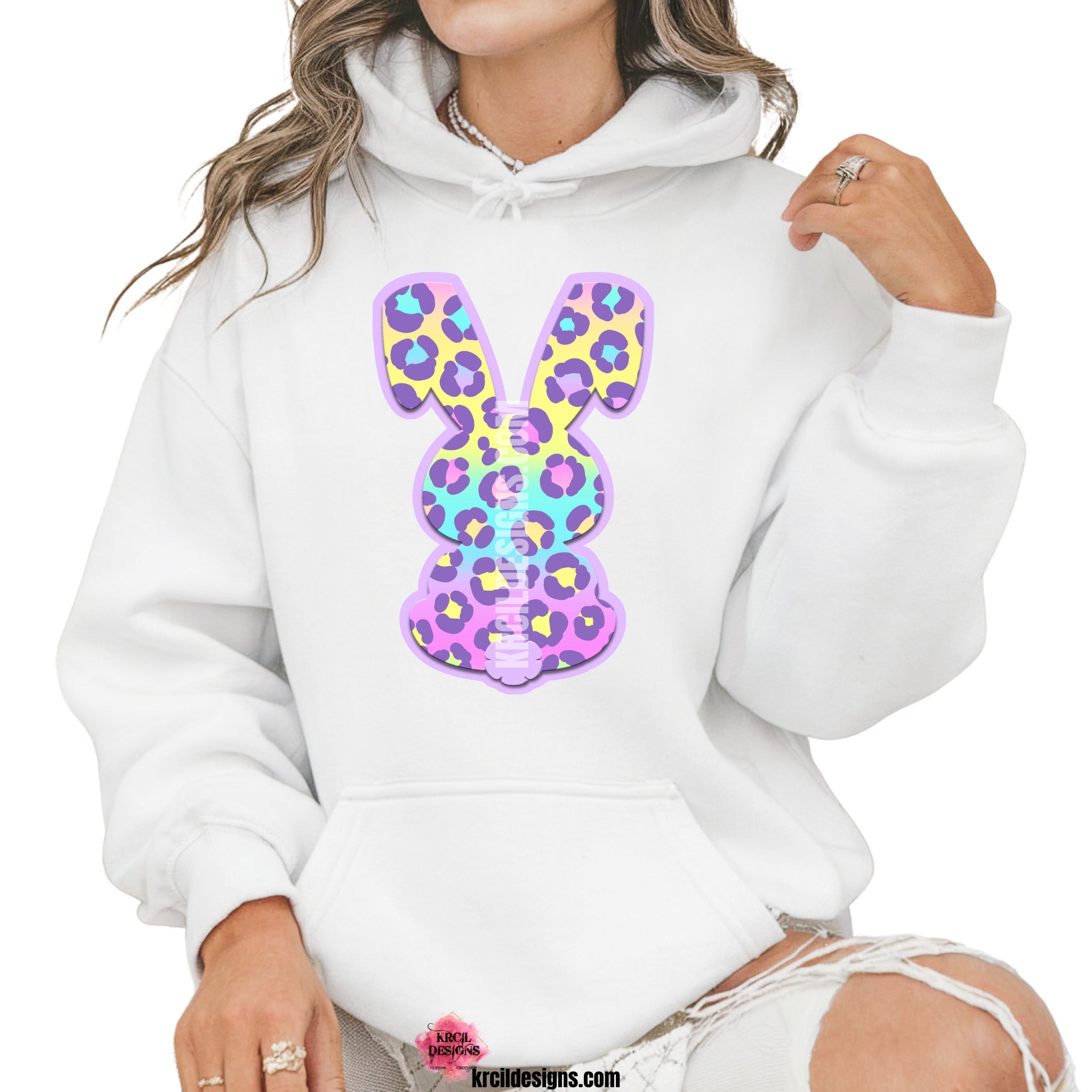 Pastel Cheetah Print Easter Bunny Sweatshirt by Krcil Designs | Make a fashion statement with our sweatshirts and hoodies! Our buttery soft cozy shirts will become your new weekend bestie! Get ready to hop into fun with our fun Easter sweater! Our graphic design, showcases a pastel cheetah print bunny and vibrant splashes of Easter colors. This Easter, celebrate in style with matching family shirts—perfect for family photos! Shop Easter Shirts at KrcilDesigns.com