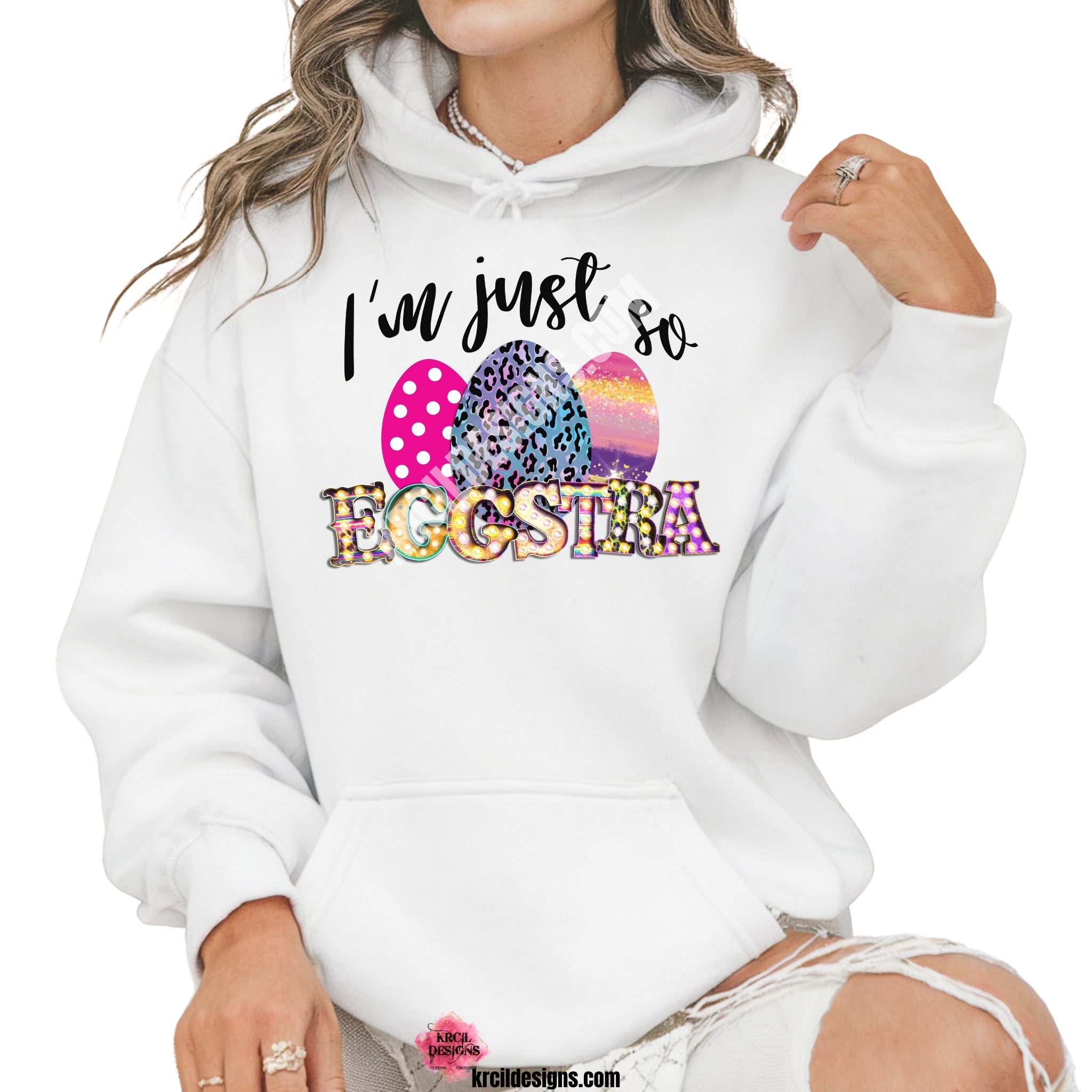 I'm just so EGGSTRA Easter Sweatshirt by Krcil Designs | Make a fashion statement with our sweatshirts and hoodies! Our buttery soft cozy shirts will become your new weekend bestie! Get ready to hop into fun and show off your vibrant personality with our "I'm just so EGGSTRA" Easter shirt! Our graphic design, showcasing vibrant, bright, colorful Easter eggs and a fun playful message. This Easter, celebrate in style with matching family shirts—perfect for family photos! Shop Easter Shirts at KrcilDesigns.com