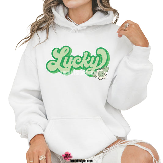 Lucky Vibes St. Patrick's Day Sweatshirt by Krcil Designs | Make a fashion statement with our crewneck sweatshirts and pullover hoodies! Our buttery soft cozy shirts will become your new weekend bestie! Get your green on this St. Patty's Day! Run your errands in style with our St. Patty's Day tote bag! Our graphics showcases the word LUCKY in bold retro style green letters, outlined in two shades of green, adorned with shamrocks and a daisy. Shop Tote Bags at KrcilDesigns.com