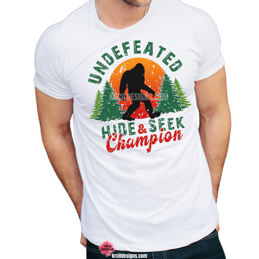 Show off your sense of humor with our Bigfoot T-Shirt "Undefeated Hide & Seek Champion" Sasquatch T-Shirt by Krcil Designs! Featuring Bigfoot! The Bigfoot Tee that's a conversation starter at the Bigfoot Festival or on Bigfoot Day. Don't miss the fun — grab your Sasquatch Tee before it disappears into the woods! Give the gifts for Bigfoot lovers that make them roar with laughter! Keep the Bigfoot Legend Alive! Sasquatch: The Legend of Bigfoot! Shop Bigfoot Gifts at KrcilDesigns.com