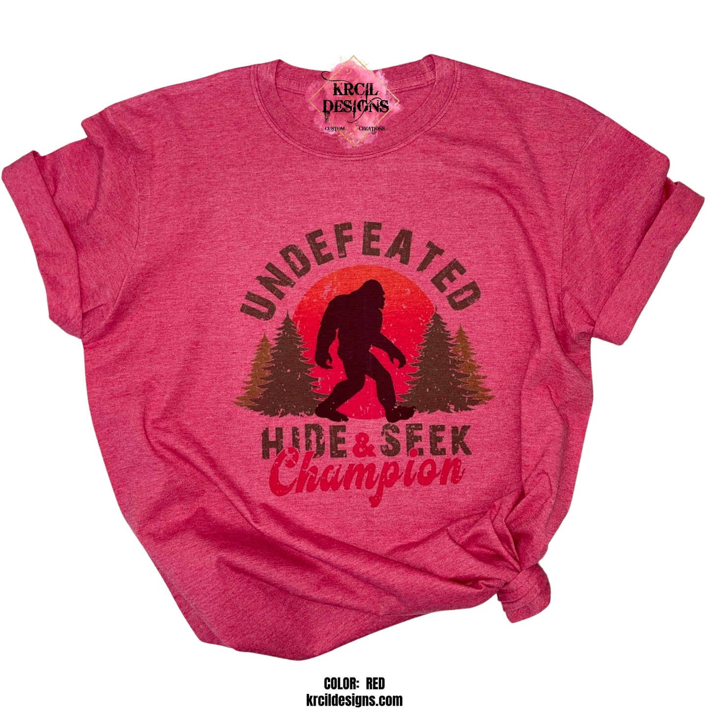 RED | Show off your sense of humor with our Bigfoot T-Shirt "Undefeated Hide & Seek Champion" Sasquatch T-Shirt by Krcil Designs! Featuring Bigfoot! The Bigfoot Tee that's a conversation starter at the Bigfoot Festival or on Bigfoot Day. Don't miss the fun — grab your Sasquatch Tee before it disappears into the woods! Give the gifts for Bigfoot lovers that make them roar with laughter! Keep the Bigfoot Legend Alive! Sasquatch: The Legend of Bigfoot! Shop Bigfoot Gifts at KrcilDesigns.com