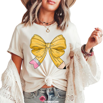 Coquette Pencil Bow Teacher T-Shirt by Krcil Designs | Make a fashion statement with our graphic tees t-shirts! Our buttery soft cozy tees will become your new weekend bestie! Get schooled in style with our Teacher Shirt! Featuring a coquette bow in a pencil pattern, this Teacher Tee is the one you need! Add your teachers name! This Teacher's Day give a Teacher Gift that Teacher's Love! Shop Teacher Shirts at KrcilDesigns.com