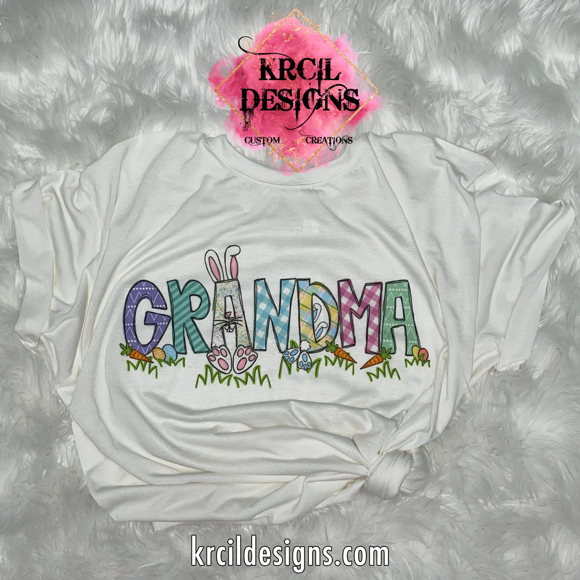 GRANDMA | White | Your Name Easter T-Shirt by Krcil Designs | Our custom t-shirt, features your name, one lucky letter will be transformed into an adorable Easter bunny, while playful bunnies hop into the other letters. Surrounding the letters are colorful Easter eggs, carrots, and the letters atop a row of grass. Personalized T-Shirt—add the kids names and make it truly yours! This Easter, celebrate in style with matching family t-shirts—perfect for family photos! Shop Easter Shirts at KrcilDesigns.com