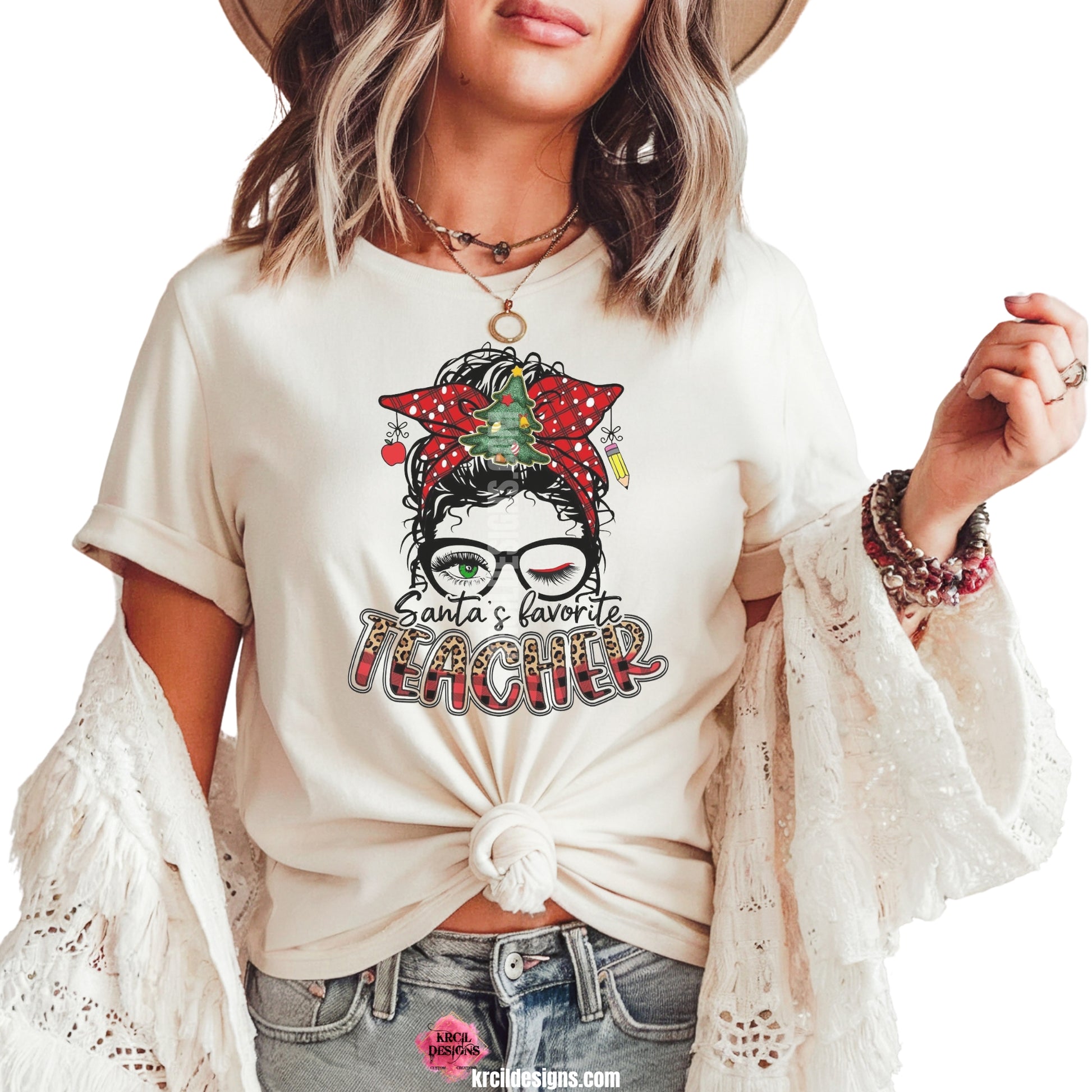 Santa's Favorite Teacher Christmas T-Shirt by Krcil Designs | Make a fashion statement with our graphic tees t-shirts! Our buttery soft cozy tees will become your new weekend bestie! Meet Santa's Favorite Teacher on this teacher shirt, all dressed up with a merry curly hair bun adorned with twinkling Christmas lights and festive ornaments, crowned with a splendid bow and a Christmas Tree at its center. She adds extra sparkle with her stylish glasses. Shop Christmas Tees at KrcilDesigns.com