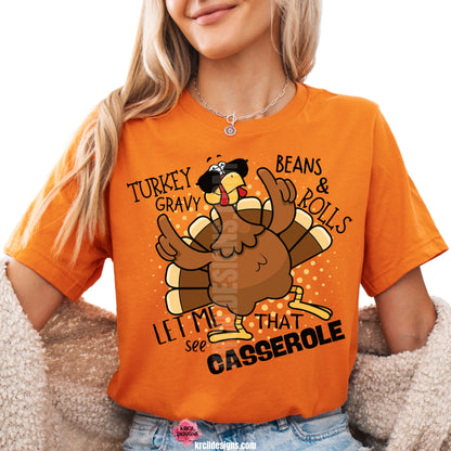 Turkey Gravy Beans & Rolls Let Me See That Casserole Thanksgiving Shirt by Krcil Designs | Make a fashion statement with our graphic tees t-shirts! Our buttery soft cozy tees will become your new weekend bestie! Dress to impress with clothes that have laugh-out-loud jokes—Introducing our Funny Thanksgiving Shirts. This holiday season, celebrate in style with funny Thanksgiving shirts—perfect for family photos! Shop Thanksgiving Shirts at KrcilDesigns.com