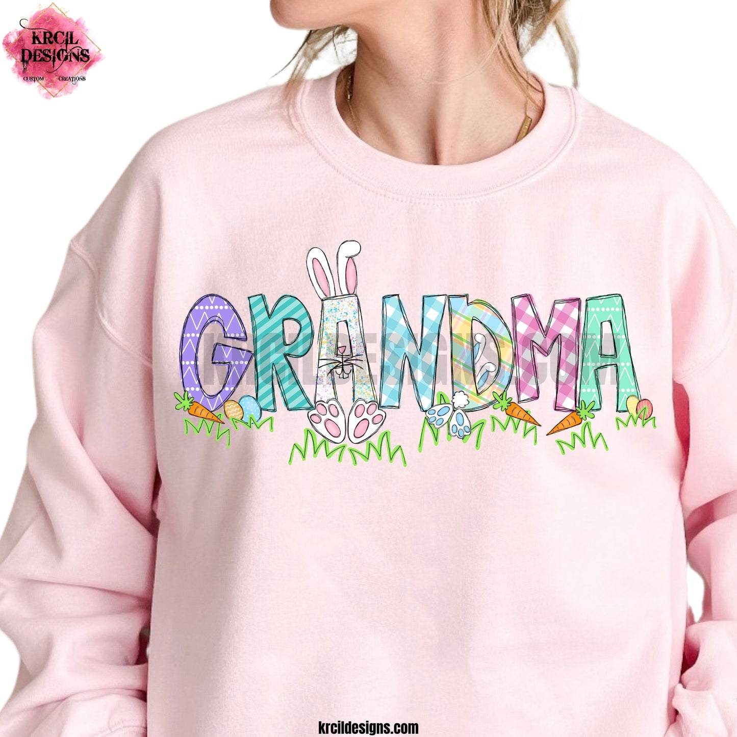 GRANDMA | Your Name Easter Sweatshirt by Krcil Designs | Our custom sweatshirt, features your name, one lucky letter will be transformed into an adorable Easter bunny, while playful bunnies hop into the other letters. Surrounding the letters are colorful Easter eggs, carrots, and the letters atop a row of grass. Add the kids names and make it truly yours! This Easter, celebrate in style with matching family sweatshirts—perfect for family photos! Shop Easter Sweaters at KrcilDesigns.com