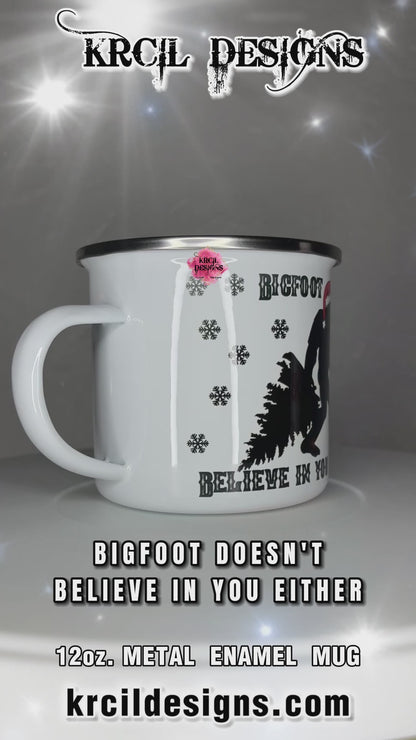 Sasquatch aka Bigfoot Christmas Mug | Personalized Mug by Krcil Designs | "Bigfoot Doesn't Believe in You Either" | This jolly Bigfoot is fully immersed in the holiday spirit, from dragging a Christmas tree to wearing a Santa hat and carrying a Bigfoot-sized candy cane. Adorned with whimsical black snowflakes, this festive mug can be personalized with your name with our black and white plaid letters for that extra touch of holiday magic. KrcilDesigns.com