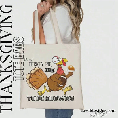 Thanksgiving Funny Tote Bags by KrcilDesigns.com | Graphic design on a canvas tote bag, featuring a cartoon turkey wearing a football helmet, holding a slice of pie topped with a dollop of whip cream on a white dinner plate, holding a football tucked under arm, and text that reads: "Oh, my! Turkey, Pie, and Touchdowns" in playful different fonts.