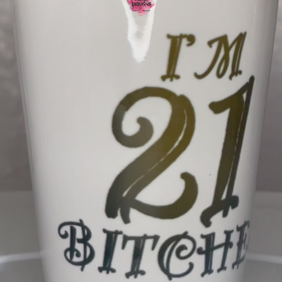 "I'm 21 Bitches" Shot Glass by Krcil Designs | Get ready to toast to the good times with our custom personalized shot glasses, perfect for the man cave. Pair them with your favorite bottle of liquor and put them in a basket for the ultimate gift. Don't forget to add the matching dish cloth tea towel set! Explore our sets and bundles options for gift ideas. Perfect for birthdays and holidays. Two toned, black interior, white exterior, ceramic shot glass. KrcilDesigns.com