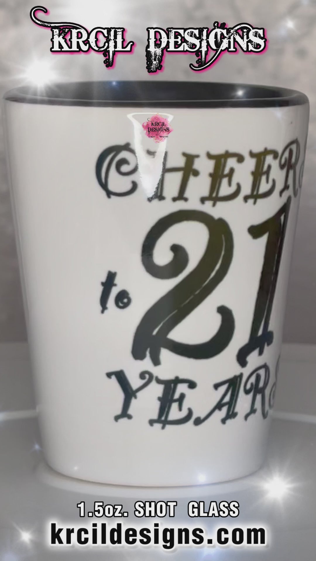 "Cheers to 21 Years" Shot Glass by Krcil Designs | Get ready to toast to the good times with our custom personalized shot glasses, perfect for the man cave. Pair them with your favorite bottle of liquor and put them in a basket for the ultimate gift. Don't forget to add the matching dish cloth tea towel set! Explore our sets and bundles options for gift ideas. Perfect for birthdays and holidays. Two toned, black interior, white exterior, ceramic shot glass. KrcilDesigns.com