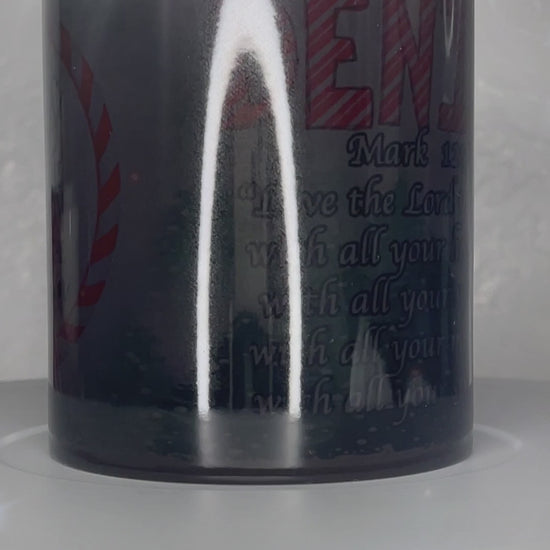 Personalized Christmas Mugs by Krcil Designs | A black color change coffee cup with your name and your favorite bible verse. The background is of green trees and falling snow. Graphic Design text reads: "Jesus Is The Reason For The Season" | Shop Christmas Mugs at KrcilDesigns.com